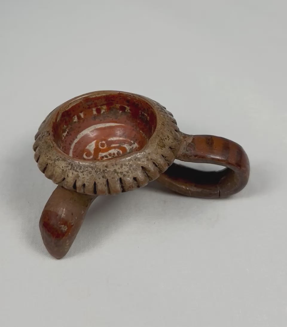 Rotating view of an authentic Pre-Columbian West Mexican miniature tripod ceremonial vessel, showing looped tripod leg, notched rim, red slip interior, and ancient surface patina.