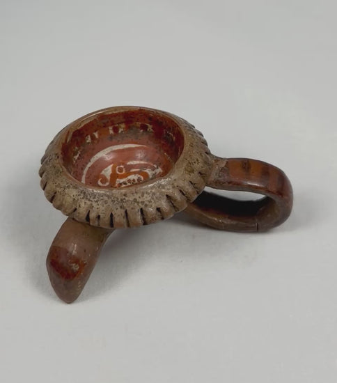 Rotating view of an authentic Pre-Columbian West Mexican miniature tripod ceremonial vessel, showing looped tripod leg, notched rim, red slip interior, and ancient surface patina.