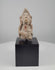 Video showcasing an ancient Indian terracotta devotional figurine from the 3rd–6th century CE, highlighting its stylized facial features, elongated headdress, reddish clay surface, natural accretions, and modern black display base.