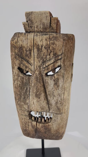 360° rotation video of early 20th-century ritual hardwood mask from Northern Thailand or Laos showing angular carving, rich patina, and traces of ceremonial soot.
