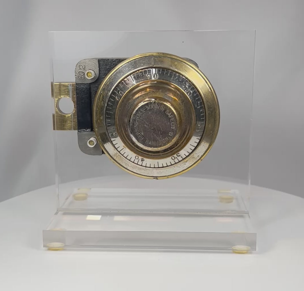 Antique Herring Hall Marvin safe lock mechanism rotating view showing brass dial and exposed internal components
