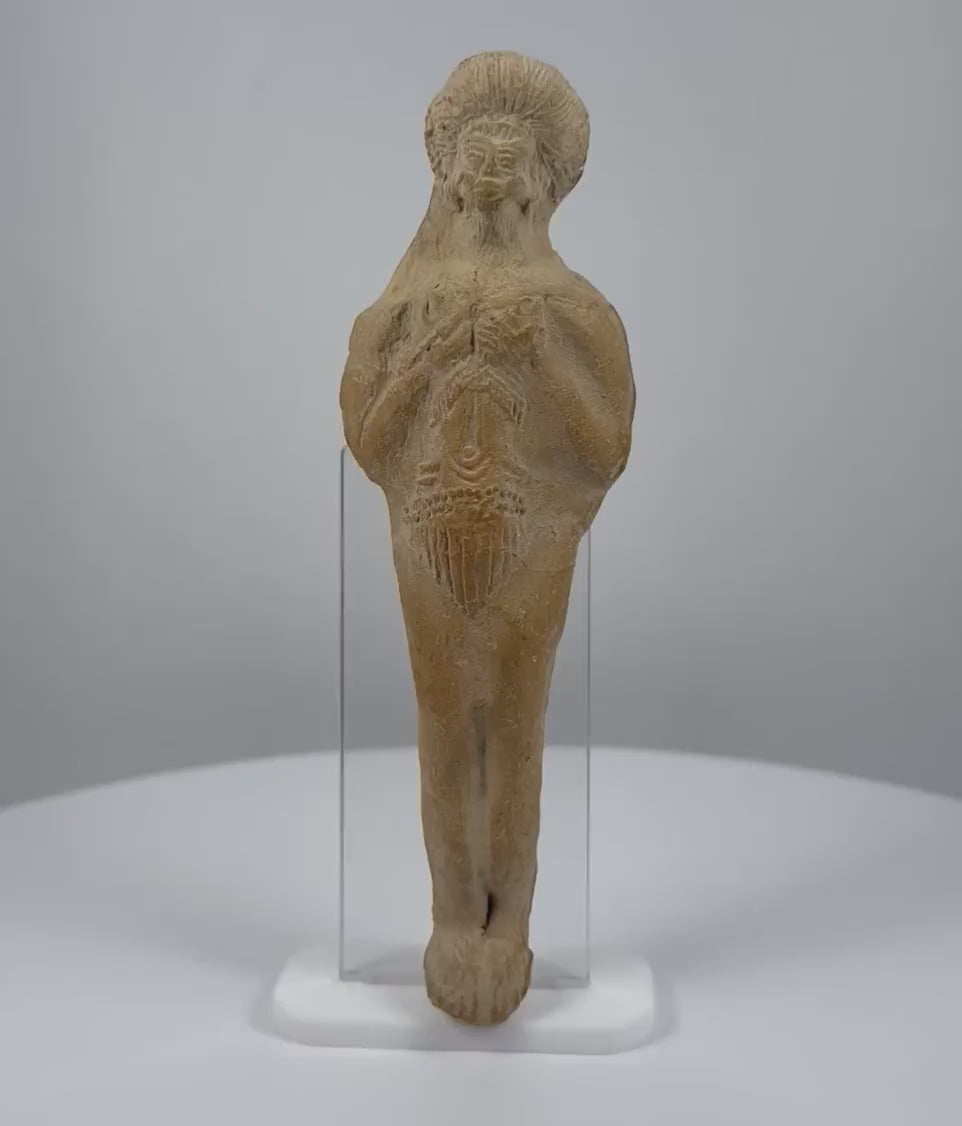 Ancient Roman terracotta fertility votive figure dating to the 1st–3rd century CE, featuring raised arms with sculpted fingers, stylized facial features, traditional hairstyle, intricate incised torso decorations, hand-formed clay construction, natural mineral deposits, and aged earthen patina.