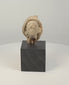 Rotating 360-degree presentation of an ancient Greek or Roman terracotta head fragment, showing its classical facial features, headdress, weathered patina, and sculptural form.
