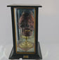Rotating view of the 19th-century mummified head known as “TIC,” a genuine sideshow artifact featuring clay construction and real human teeth, mounted on a brass stand inside a glass and wood display case. Captures the relic’s preserved details and historical craftsmanship.