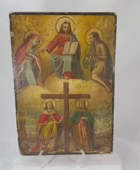 Antique Eastern Orthodox icon painted in tempera on wood, depicting Christ enthroned with Virgin Mary and St. John the Baptist above, and Saints Constantine and Helena venerating the True Cross below, photographed on a white background.