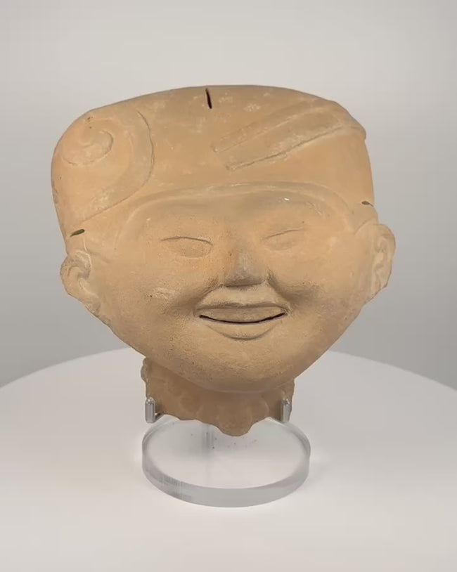 Pre-Columbian Veracruz Sonriente terracotta head with smiling expression, scroll-motif headdress and hollow ceramic construction