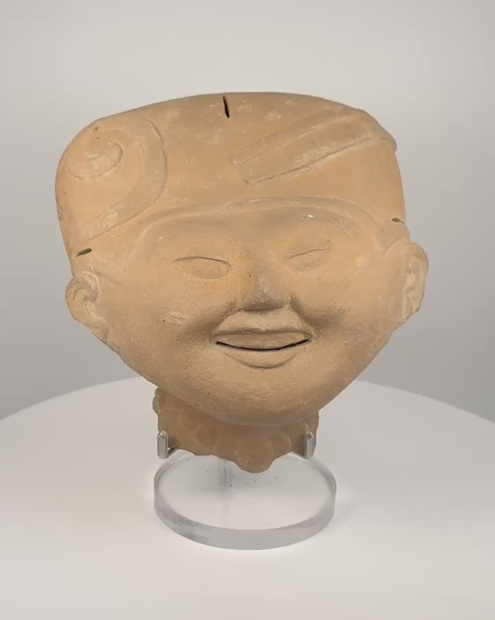 Pre-Columbian Veracruz Sonriente terracotta head with smiling expression, scroll-motif headdress and hollow ceramic construction