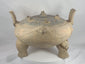 360-degree video of a large ancient Chinese terracotta zoomorphic ritual vessel from the Eastern Zhou to Han Dynasty, showcasing its pierced domed lid, tripod feet, upright handles, incised decoration, archaeological patina, and sculptural ceremonial form.