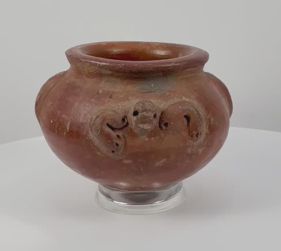 360-degree rotating view of a Pre-Columbian terracotta vessel dating to circa 1000–1500 CE, featuring sculpted ornamental handles, intricate decorative motifs, earthy red clay, and a naturally weathered surface.