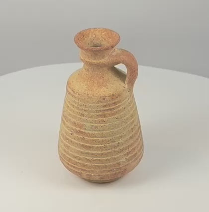 Video showing an ancient Roman–Late Antique terracotta juglet with flared rim, loop handle and horizontally ridged body