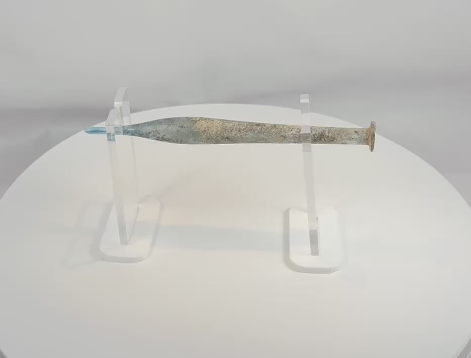 360-degree view of an ancient Roman blue glass candlestick unguentarium, circa 1st–3rd Century AD, showcasing its elongated fusiform body, narrow tubular neck, flared rim, archaeological weathering, iridescence, and exceptional Roman glassmaking craftsmanship.