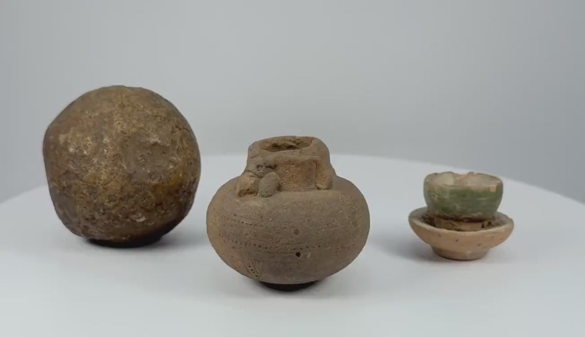 360-degree rotating video showcasing three ancient South and East Asian artifacts, including a rounded stone object, decorated earthenware jar, and small glazed ceramic cup with dish, dating to circa 500–1500 CE.