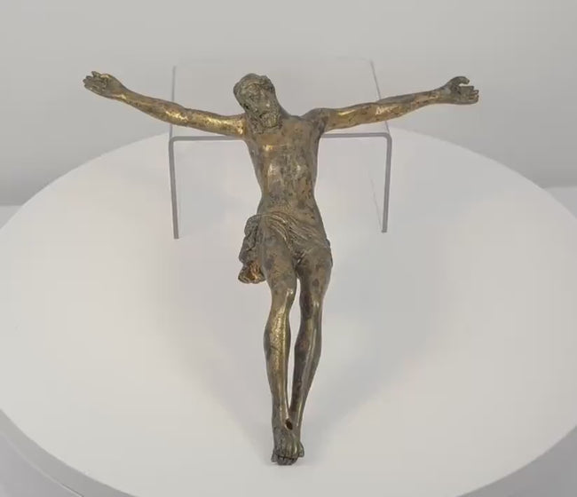 360-degree rotating view of an antique European gilt-bronze Corpus Christi crucifix figure, dating to the 16th–17th century. Depicts Jesus Christ with outstretched arms, bowed head, elongated anatomy, crossed feet, and a finely sculpted draped loincloth. The rotation reveals surviving historic gilding, aged bronze patina, intricate sculptural details, and the reverse of this Renaissance to early Baroque religious artifact.