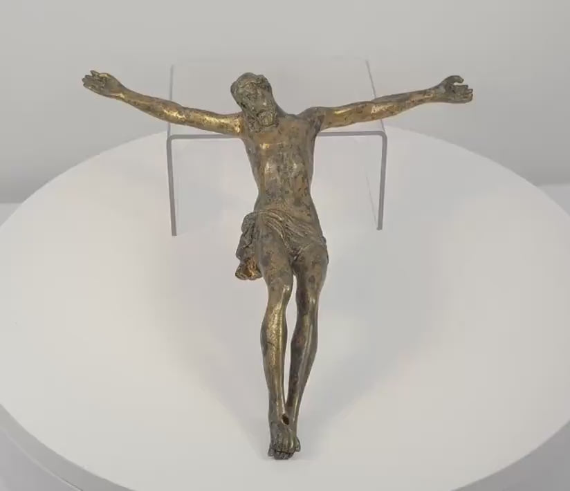 360-degree rotating view of an antique European gilt-bronze Corpus Christi crucifix figure, dating to the 16th–17th century. Depicts Jesus Christ with outstretched arms, bowed head, elongated anatomy, crossed feet, and a finely sculpted draped loincloth. The rotation reveals surviving historic gilding, aged bronze patina, intricate sculptural details, and the reverse of this Renaissance to early Baroque religious artifact.