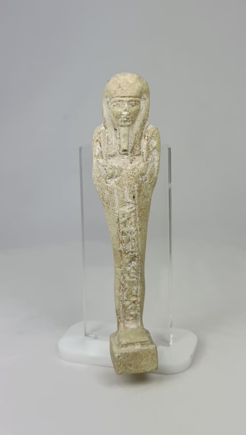 360° rotating view of an ancient Egyptian limestone ushabti with traces of pigment on a display stand