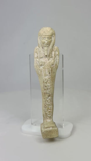 360° rotating view of an ancient Egyptian limestone ushabti with traces of pigment on a display stand