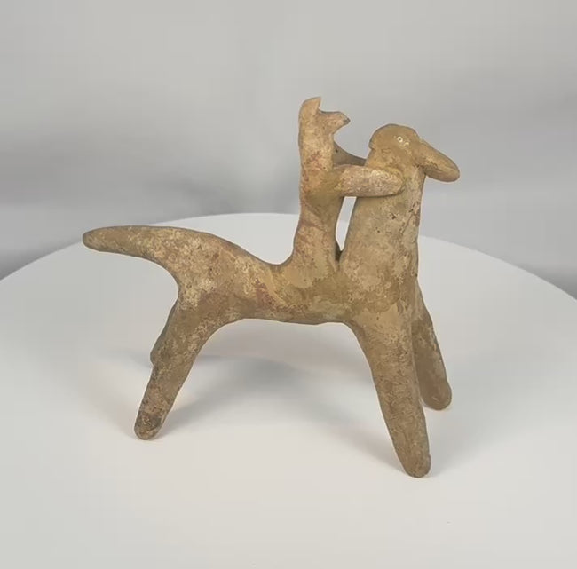 Ancient Boeotian Greek terracotta horse and rider votive figure dating to circa 700–500 BCE, shown in a rotating 360-degree view highlighting its stylized geometric form, surviving traces of red pigment, archaeological patina, and sculptural details. The video concludes with the original 1980 purchase receipt, export documentation, and period provenance photographs.