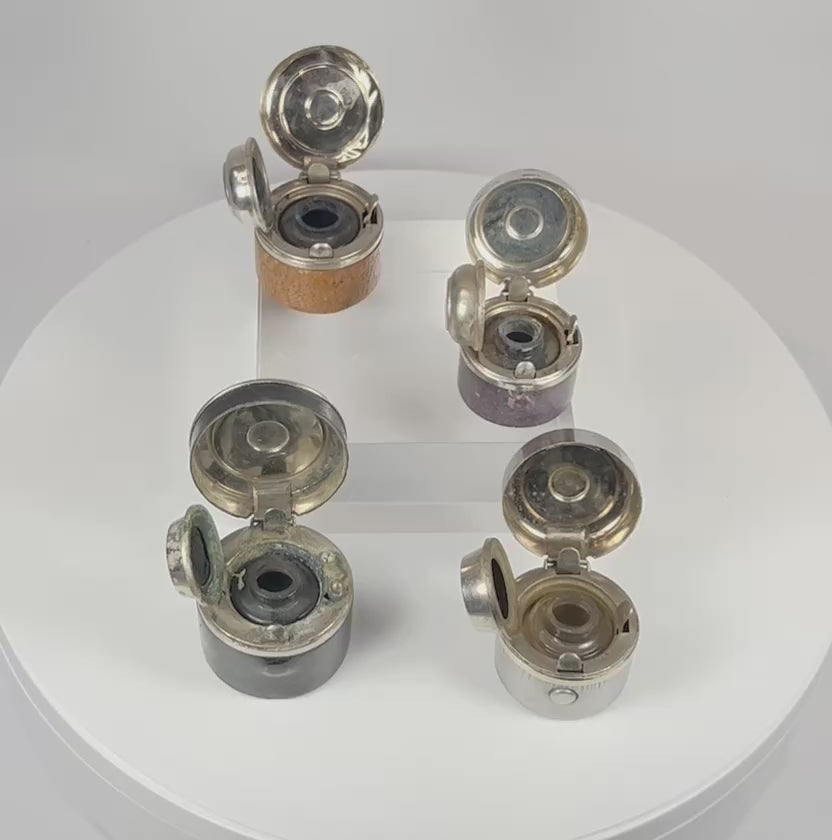 360-degree rotating view of antique portable inkwell set showing leather wrapping, metal lids, and glass reservoirs from all angles