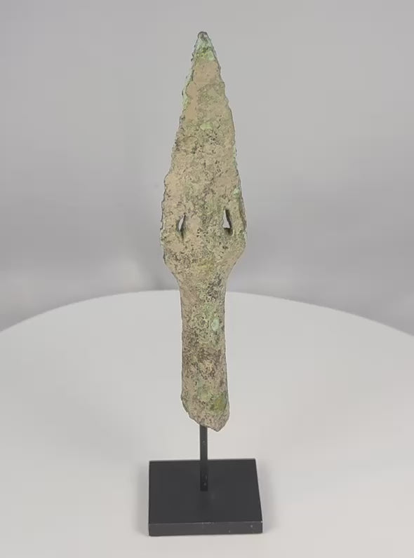 Video of an ancient Dong Son bronze spearhead with a pierced blade, socketed base, and archaeological green patina