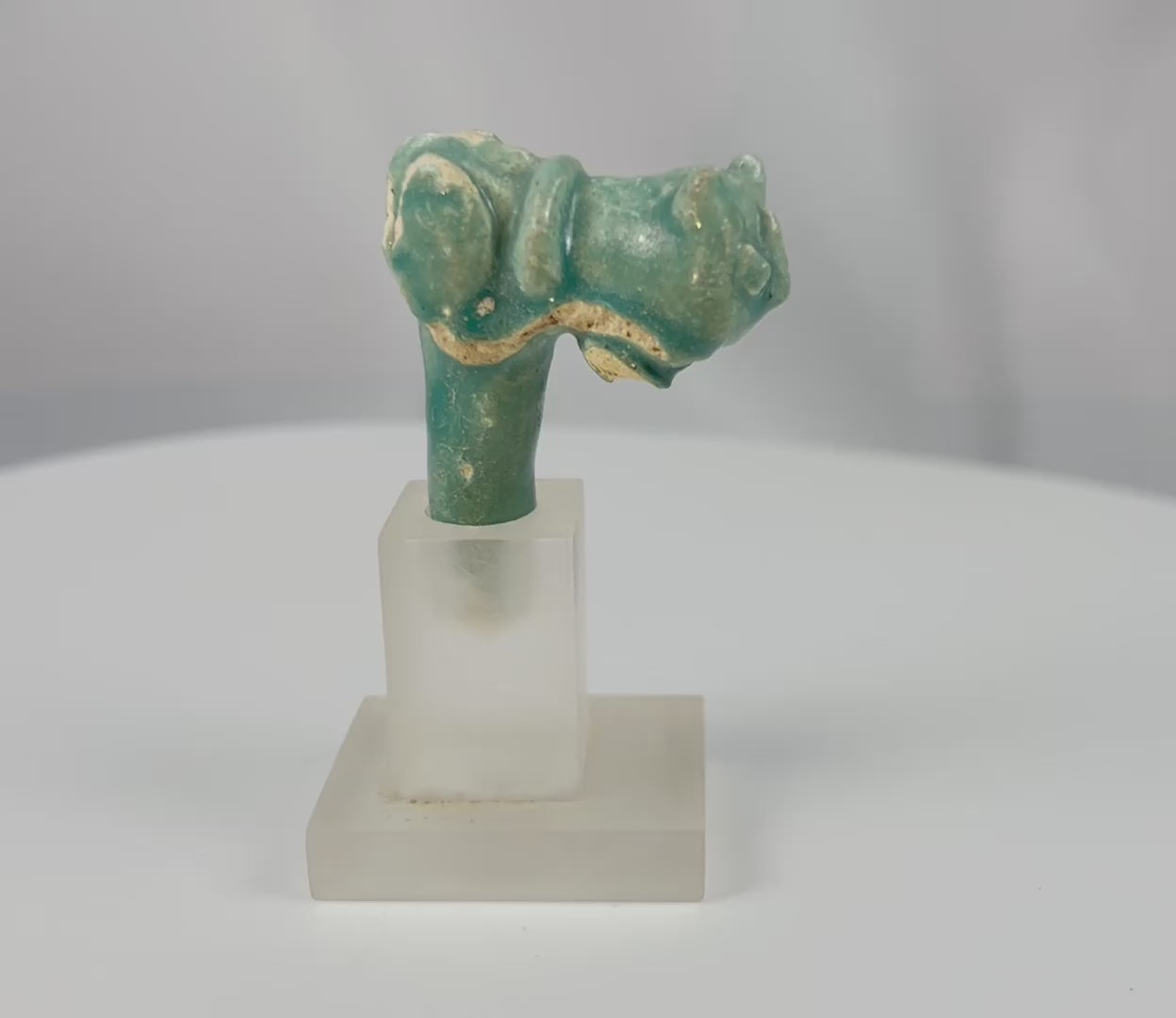 360-degree view of an ancient Egyptian blue-green faience vessel handle fragment depicting a stylized cat head representing the goddess Bastet from the Late Period to Ptolemaic era.