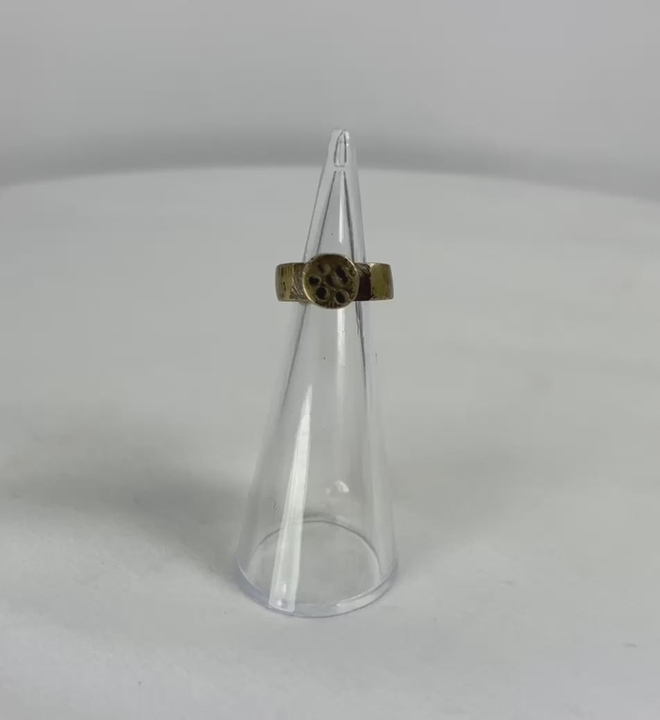 360° rotation video of ancient Roman bronze ring with rosette bezel, illustrating band shape, patina, and bezel detailing.