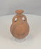 Rotating view of an ancient Cypriot Black-on-Red terracotta flask with a compact globular body, short neck, broad everted rim, opposing loop handles, orange-red slipped surface, black painted bands, flattened underside, mineral accretions, weathering, and archaeological patina