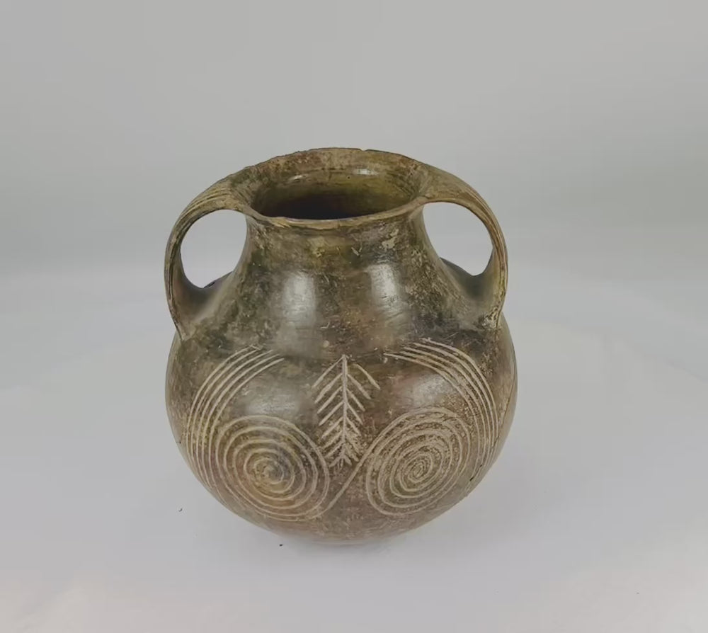 Neolithic to Early Bronze Age terracotta jug from Central or Eastern Europe, circa 3000–2000 BCE. Handmade pottery with incised geometric motifs and double handles, used for ceremonial offerings or daily storage. Reflects early European craftsmanship, symbolic artistry, and ancient ritual practices.