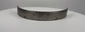 Antique 17th-century European forged steel armor band formerly held in the Higgins Armory Museum collection, featuring a thick curved structure, evenly spaced rivet holes, traditional hand-forged metalwork, natural aged patina, surface pitting, and historic wear characteristic of early modern European defensive armor.