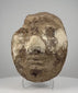 360-degree video of an ancient Egyptian stuccoed mud-and-straw funerary face fragment, showing surviving facial features, exposed plant-fibre construction, surface losses, and old collection label, formerly from the Dr. Bruce L. Ralston collection.