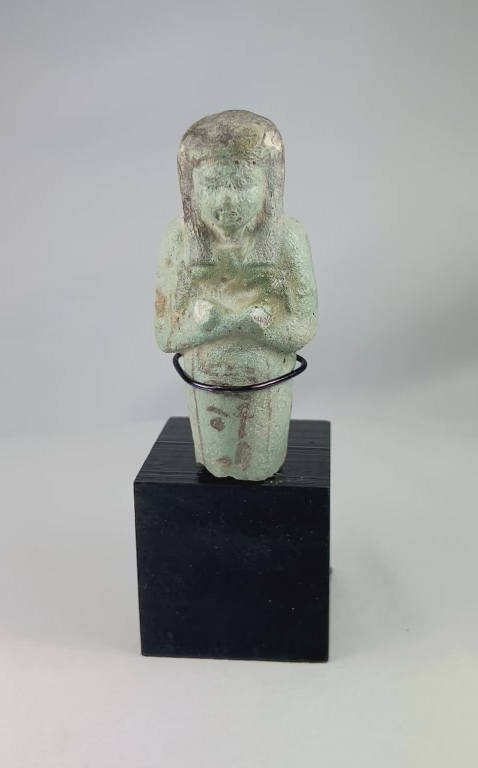 360-degree rotating view of an ancient Egyptian blue-green faience ushabti showing crossed arms, painted details, hieroglyphic inscription, and Late Period craftsmanship.