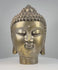 360-degree rotating view of a vintage cast bronze Buddha head, circa 1950–1990, featuring a golden patinated finish, intricate spiral curls, raised ushnisha, elongated earlobes, serene facial expression, and decorative banded neck. The video highlights detailed craftsmanship, surface oxidation, and signs of age from multiple angles.
