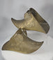 360-degree view of antique Spanish Colonial brass slipper stirrups showing enclosed riding form, relief decoration, and aged patinated surfaces.