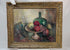 Early 20th-century American oil on canvas still life by John Hubbard Rich, depicting apples, grapes, a wine bottle, and goblet in a giltwood frame, photographed against a white background.