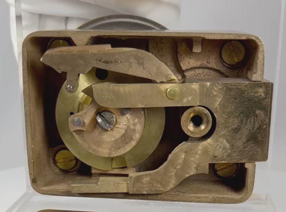 view of antique safe lock mechanism back showing internal components and original back plate
