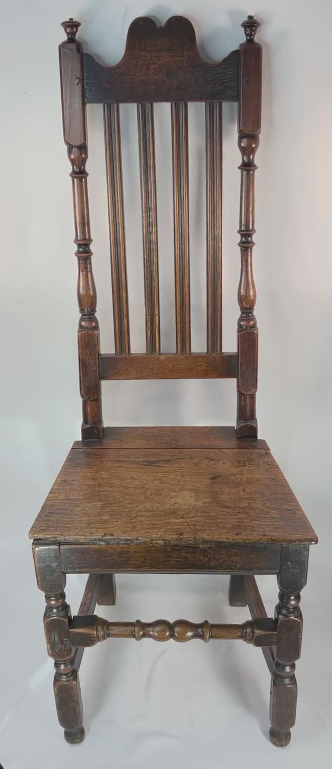 360 degree view of late 17th century English provincial oak chair showing tall splat back plank seat and turned stretcher construction