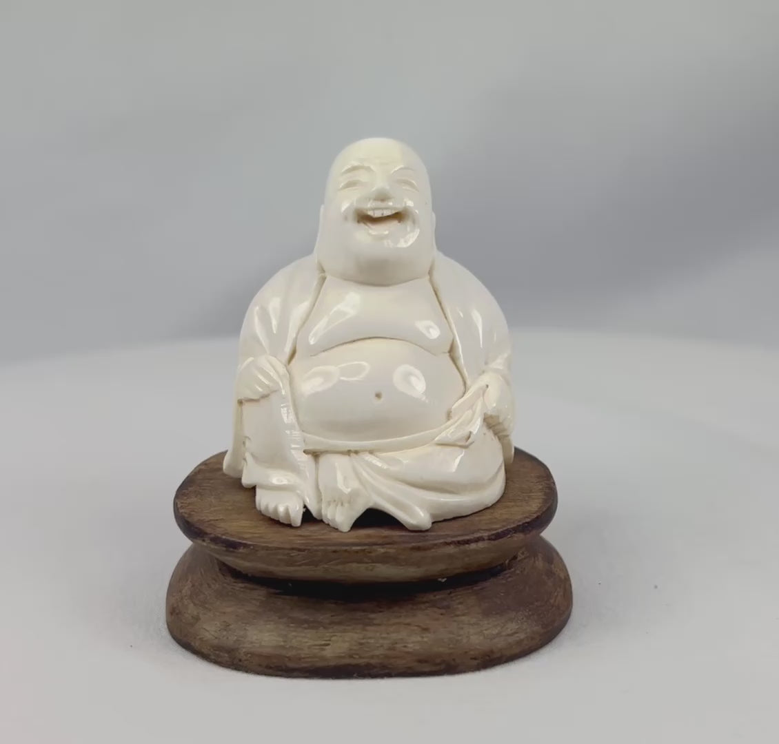 Rotating showcase video of East Asian Budai carving with polished finish and joyful expression antique collectible.