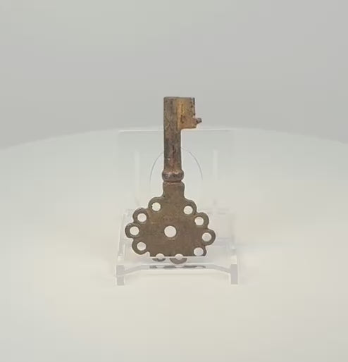 Rotating 360-degree view of a Spanish colonial iron key, circa 16th–18th century, showing its pierced head, compact bit, forged construction, and aged oxidized surface.