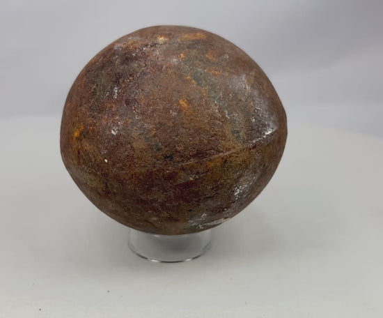 360-degree rotating view of an antique iron cannonball showing rusted surface, patina, and historic battlefield wear from the 18th–19th century