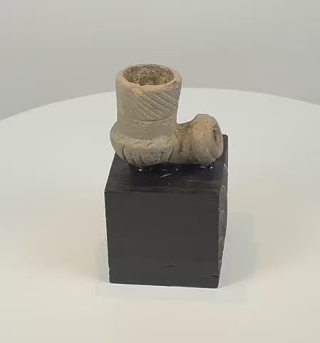 Video showcasing an ancient North American carved stone elbow pipe with a deep smoking bowl, geometric engraving, open stem socket and archaeological patina, attributed circa 800–1200 CE