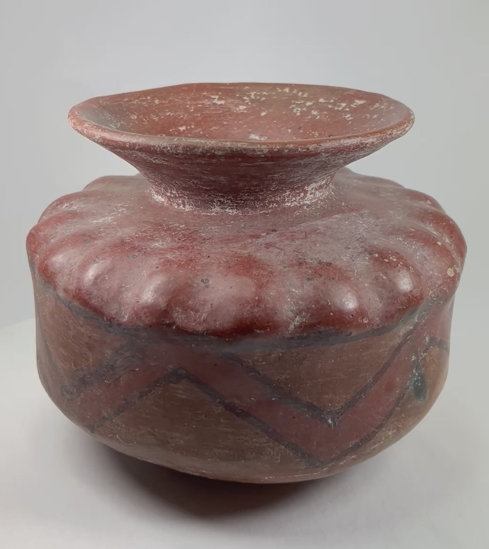 360-degree rotating video view of an authentic Pre-Columbian globular ceramic vessel with geometric painted patterns.