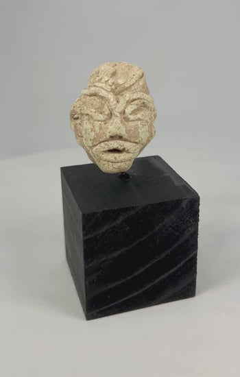 Ancient Mesopotamian carved stone idol head, 2000–800 BCE, Near East votive figure fragment with almond-shaped eyes and broad nose on display stand