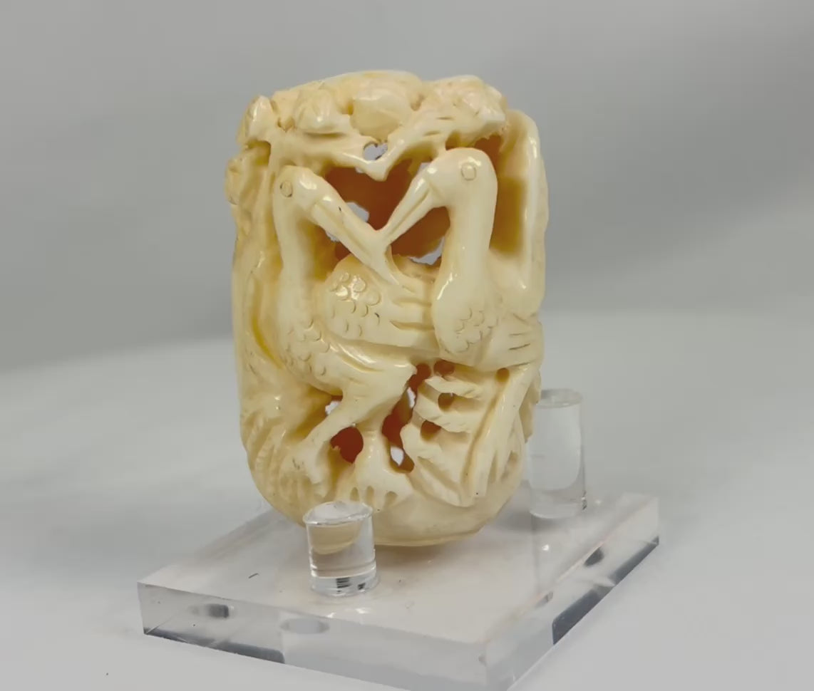 360-degree view of an antique Japanese bone carving, showcasing intricately pierced birds and foliage details from all angles, Meiji to early 20th century.