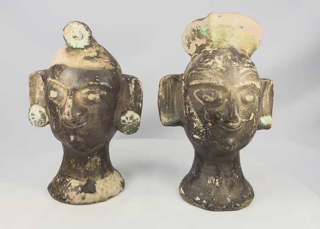 Matched pair of Pre-Columbian-inspired terracotta head sculptures rotating video showing stylized faces, circular ear ornaments, domed headdresses, and dark slipped surfaces, 20th Century
