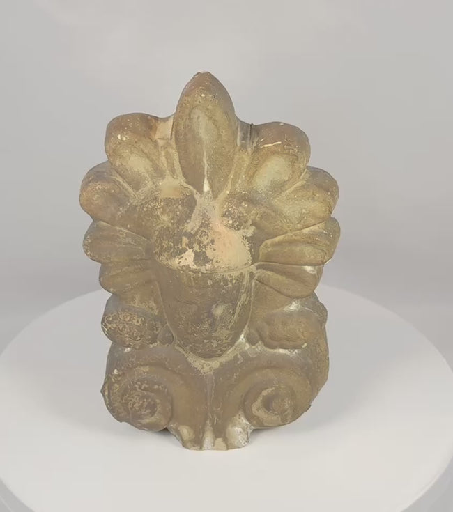 Rotating view of an antique Greek terracotta antefix (akrokeramo) featuring a classical human face beneath a palmette crown, decorative volutes, weathered architectural patina, and traditional fired clay construction from the late 19th to early 20th century.