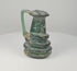 Video showcasing a Late Roman blue-green blown-glass jug with applied coiled trail decoration, iridescent surface, flared rim, and ancient burial patina