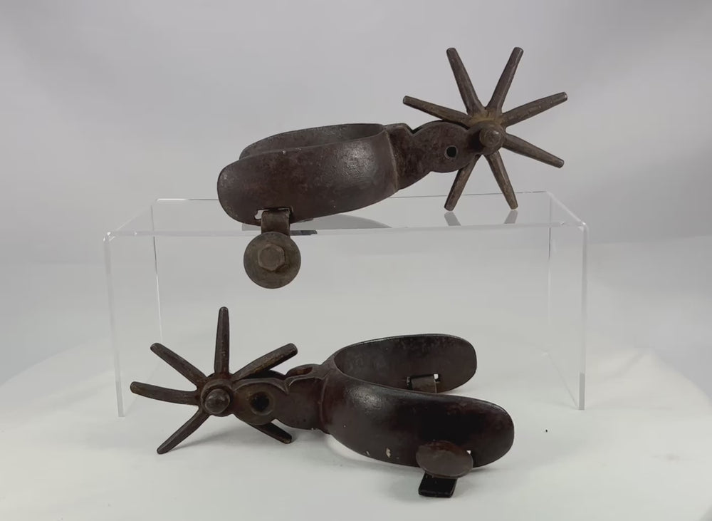 360-degree video of antique Mexican Charro cowboy spurs showing hand-forged iron construction, large star rowels, rich age patina, and authentic working wear