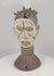 Rotating view of a Nigerian Igbo Janus dance crest featuring opposing carved human faces, original white, black, red, and purple pigments, projecting coiffure elements, a ringed neck, and a perforated base associated with ceremonial masquerade traditions of the mid-20th century.