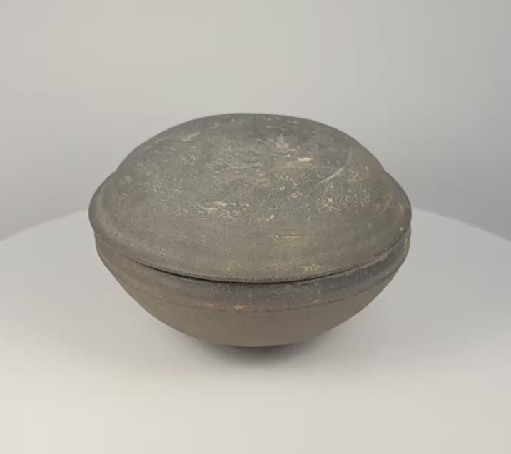 360-degree rotating view of an ancient Chinese gray pottery covered bowl attributed to the Tang Dynasty, showing the fitted domed lid, rounded body, interior, underside, and aged earthenware surface.