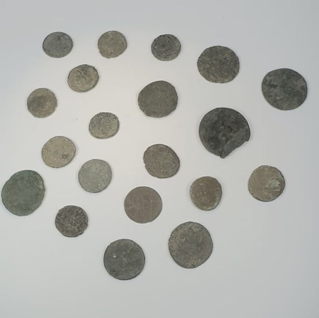 360-degree overview of a collection of twenty ancient Roman, Late Antique, and possible early Byzantine bronze coins showing varied flan sizes, patination, corrosion, and surviving design details.