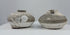 Video showcasing a pair of Sawankhalok shipwreck jarlets, circa the 15th–16th century, with squat stoneware bodies, flared rims, partial brown glaze, and marine encrustations.